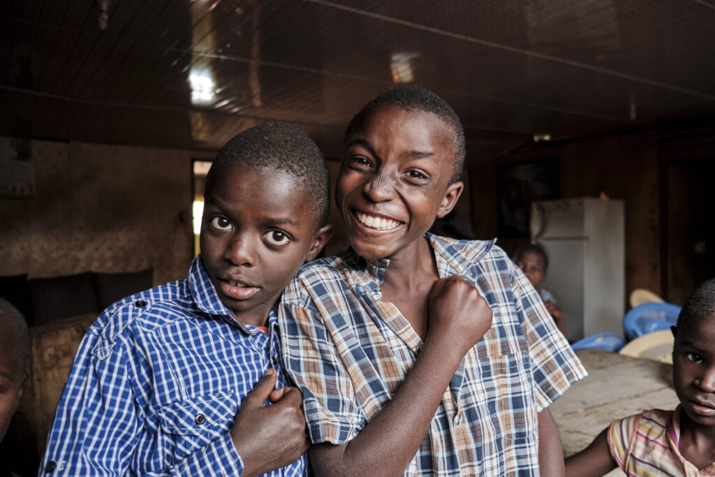 Two boys posing for photograph, Praise Gate foster home, Kenya